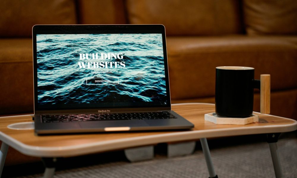a laptop computer sitting on top of a wooden table